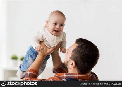 family, childhood, babyhood and people concept - happy little baby boy with father at home. happy little baby boy with father