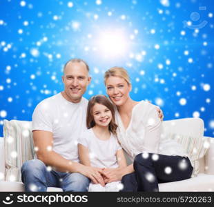 family, childhood, christmas holidays and people concept - smiling mother, father and little girl over blue snowy background