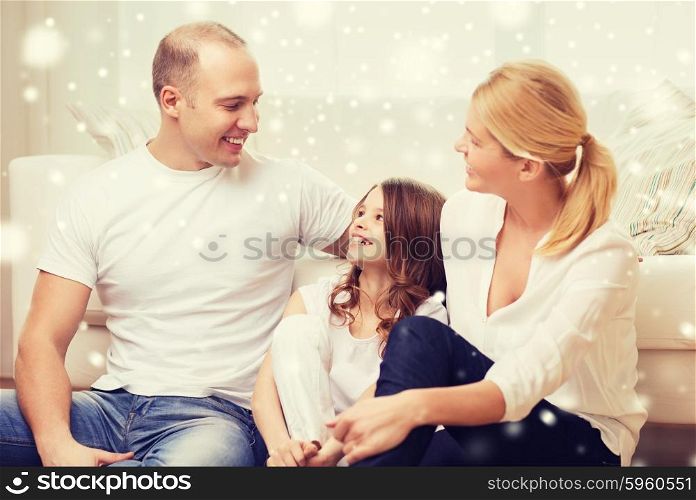 family, childhood, communication, people and home concept - smiling parents with little girl talking at home