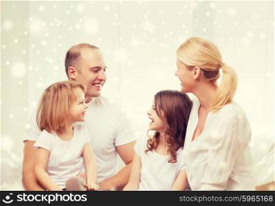 family, childhood, communication, people and home concept - smiling parents with two little girls talking at home