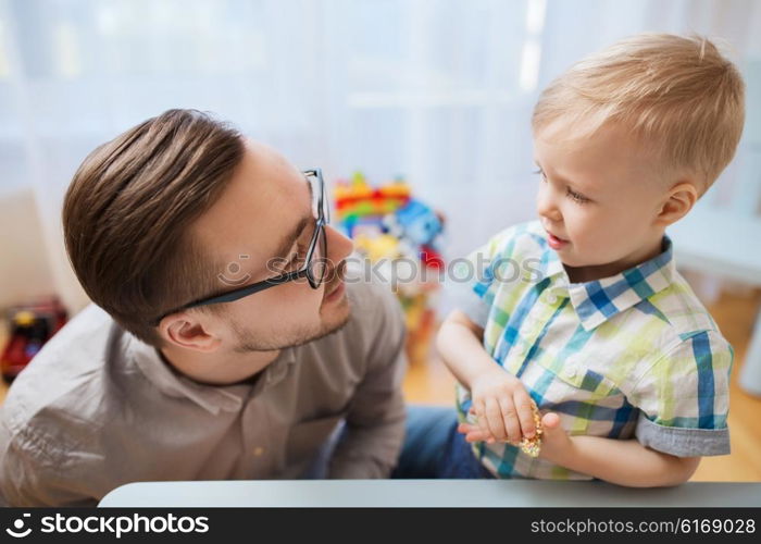 family, childhood, creativity, activity and people concept - happy father and little son playing with ball clay at home