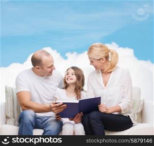 family, childhood, dream and people - smiling mother, father and little girl reading book over blue sky and cloud background