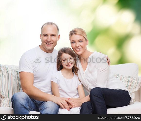 family, childhood, ecology and people concept - smiling mother, father and little girl over green background