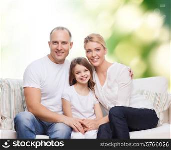 family, childhood, ecology and people concept - smiling mother, father and little girl over green background