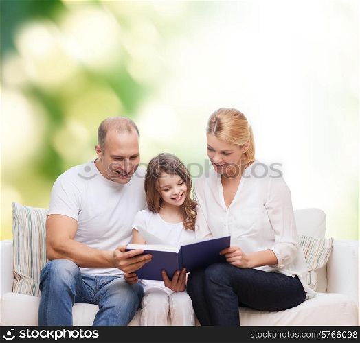 family, childhood, ecology and people - smiling mother, father and little girl reading book over green background