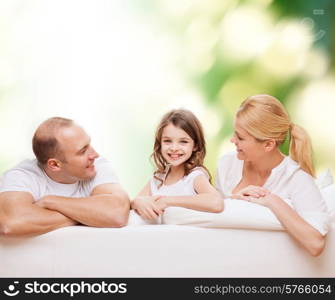 family, childhood, ecology and people - smiling mother, father and little girl over green background