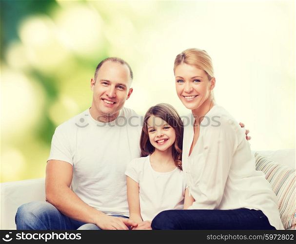 family, childhood, ecology and people - smiling mother, father and little girl over green background