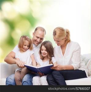 family, childhood, ecology and people - smiling mother, father and little girls reading book over green background