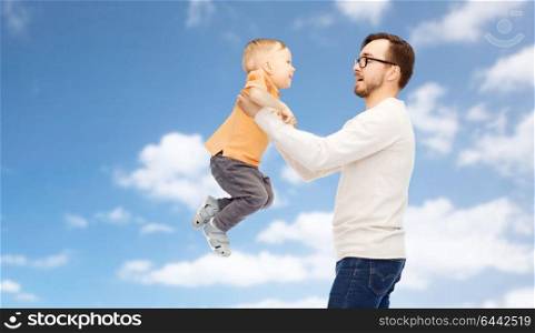 family, childhood, fatherhood and people concept - happy father and little son playing and having fun over blue sky and clouds background. father with son playing and having fun