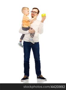 family, childhood, fatherhood, healthy eating and people concept - happy father and and little son with green apple