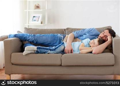 family, childhood, fatherhood, leisure and people concept - portrait of happy father and little son sleeping on sofa at home. happy father and son sleeping on sofa at home
