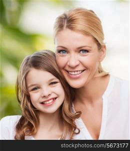 family, childhood, happiness, ecology and people - smiling mother and little girl over green background