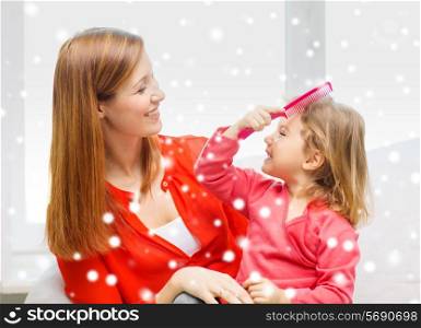 family, childhood, holidays and people concept - happy mother and daughter with comb at home
