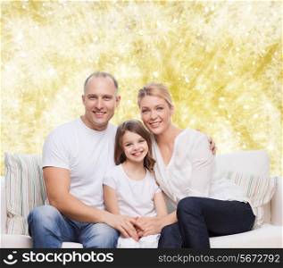 family, childhood, holidays and people concept - smiling mother, father and little girl over yellow lights background