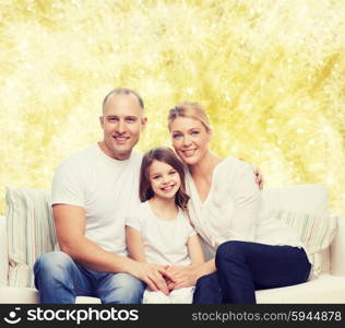 family, childhood, holidays and people concept - smiling mother, father and little girl over yellow lights background