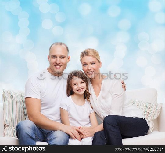 family, childhood, holidays and people concept - smiling mother, father and little girl over blue lights background