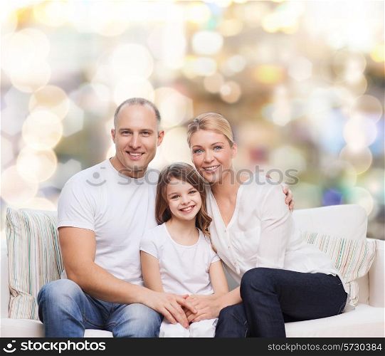 family, childhood, holidays and people concept - smiling mother, father and little girl over lights background