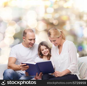 family, childhood, holidays and people - smiling mother, father and little girl reading book over lights background