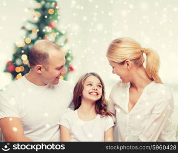 family, childhood, holidays and people - smiling mother, father and little girl over living room and christmas tree background