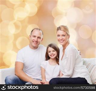 family, childhood, holidays and people - smiling mother, father and little girl over beige lights background