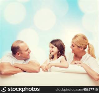 family, childhood, holidays and people - smiling mother, father and little girl over blue lights background