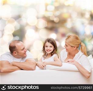 family, childhood, holidays and people - smiling mother, father and little girl over lights background