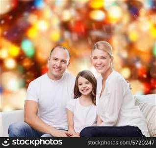 family, childhood, holidays and people - smiling mother, father and little girl over red lights background
