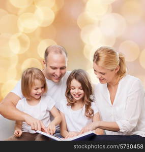 family, childhood, holidays and people - smiling mother, father and little girls reading book over beige lights background