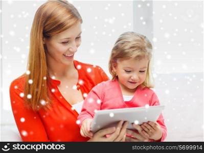 family, childhood, holidays, technology and people concept - happy mother and daughter with tablet pc computer at home