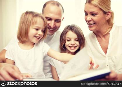 family, childhood, literature and people - happy mother, father and little girls reading book at home