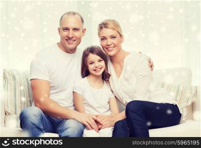 family, childhood, people and home concept - smiling parents with little girl sitting and hugging at home