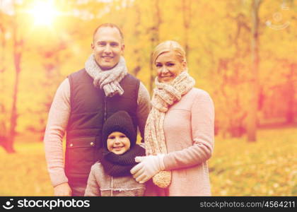 family, childhood, season and people concept - happy family in autumn park