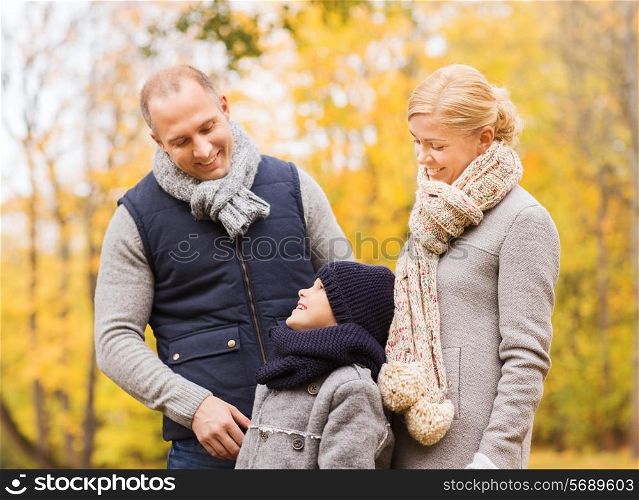 family, childhood, season and people concept - happy family in autumn park