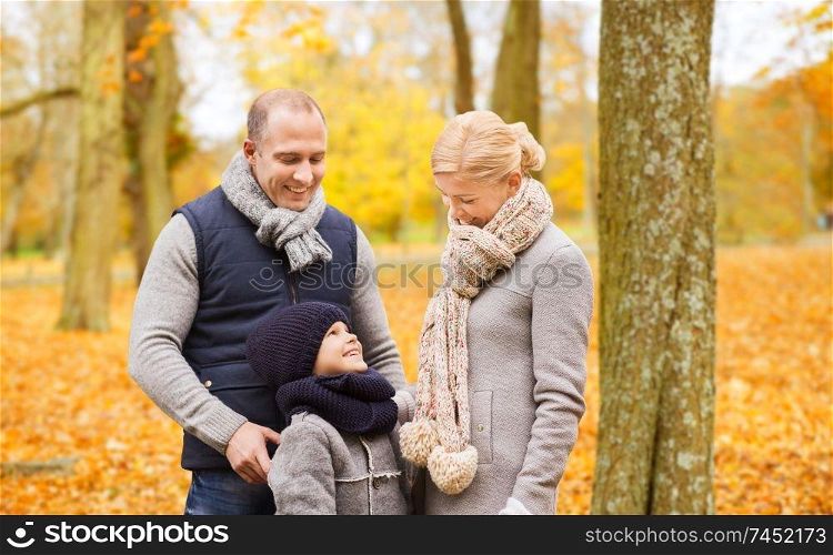 family, childhood, season and people concept - happy family in autumn park. happy family in autumn park