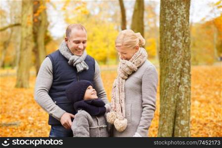 family, childhood, season and people concept - happy family in autumn park. happy family in autumn park