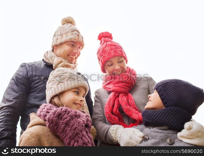 family, childhood, season and people concept - happy family outdoors