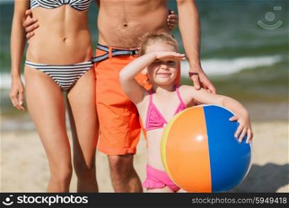 family, childhood, travel and people concept - close up of happy man, woman and little girl in sunglasses with inflatable ball on summer beach