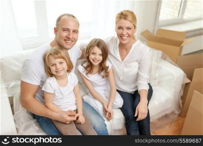 family, children, accommodation and home concept - smiling parents and two little girls moving into new home