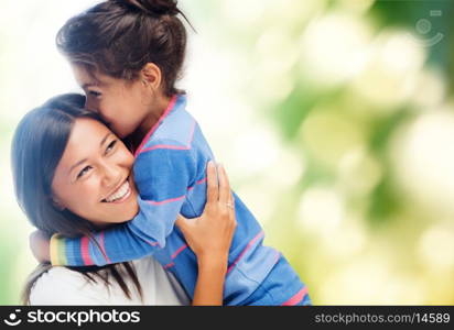 family, children and happy people concept - hugging mother and daughter