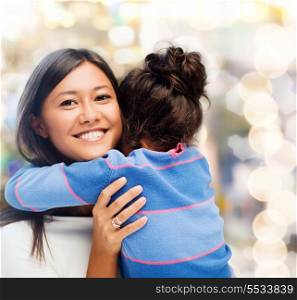 family, children and happy people concept - hugging mother and daughter