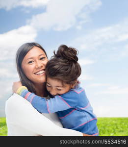 family, children and happy people concept - hugging mother and daughter