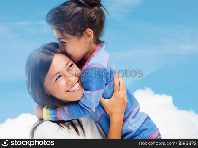 family, children and happy people concept - hugging mother and daughter