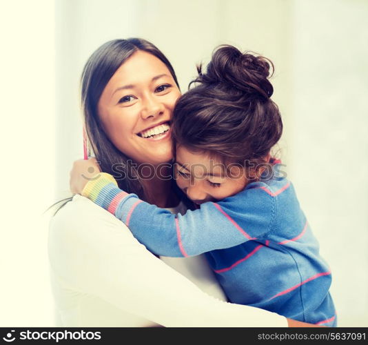 family, children and happy people concept - hugging mother and daughter