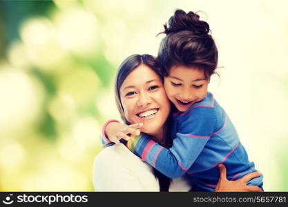 family, children and happy people concept - hugging mother and daughter