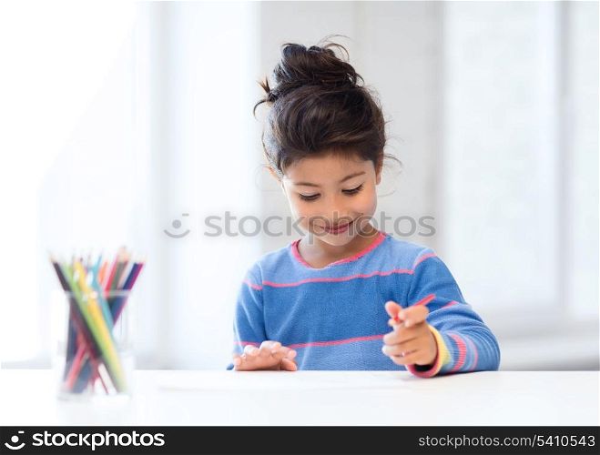 family, children and happy people concept - little girl drawing