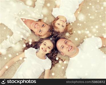 family, children and home concept - smiling family with and two little girls lying in circle on floor over snowflakes background