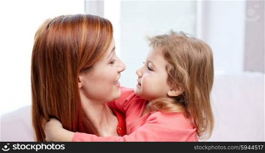 family, children and people concept - happy mother and little daughter hugging at home