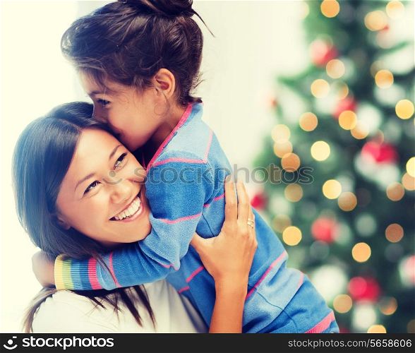 family, children, christmas, x-mas and happy people concept - hugging mother and daughter