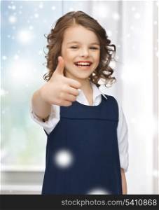 family, children, christmas, x-mas, love concept - beautiful pre-teen girl showing thumbs up