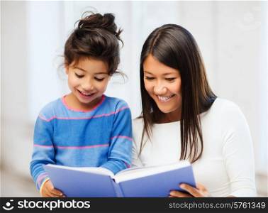 family, children, education, school and happy people concept - mother and daughter with book